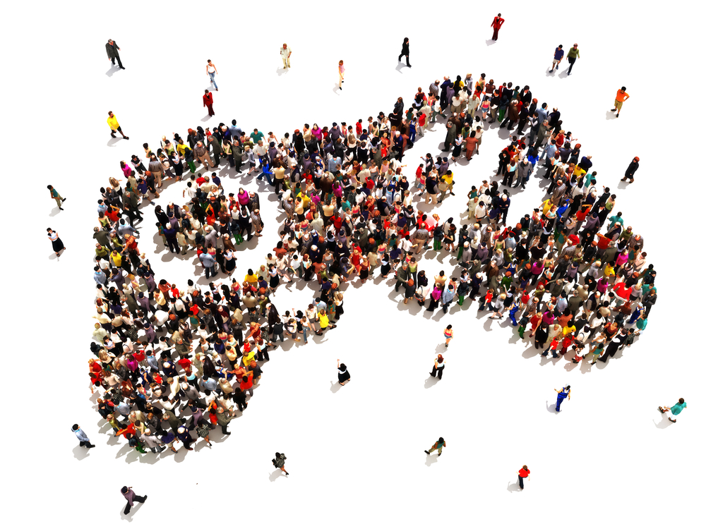 Overhead image of people lined up to form the shape of a video game controller.