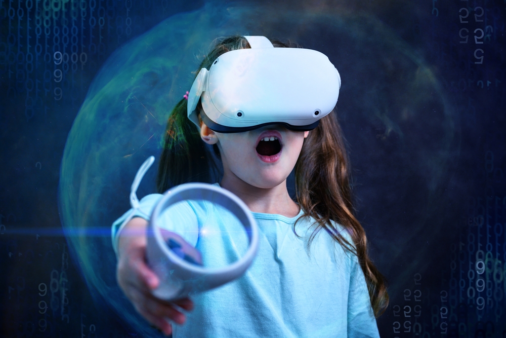 A very young person visits the metaverse with goggles and a handheld controller.